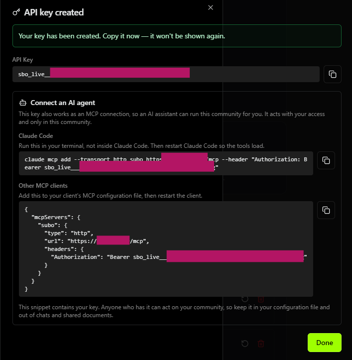 The confirmation panel right after creating an agent key: the key, then the "Connect an AI agent" section with the Claude Code command, the JSON block and their copy buttons